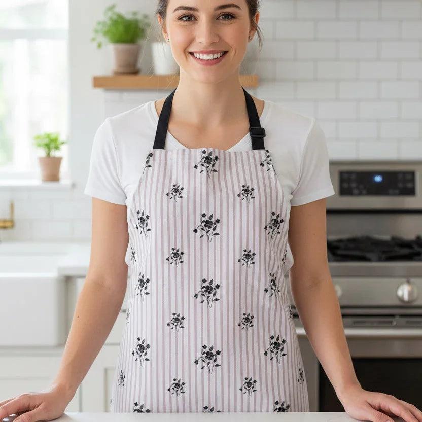 Woman in a floral striped apron standing in a modern kitchen