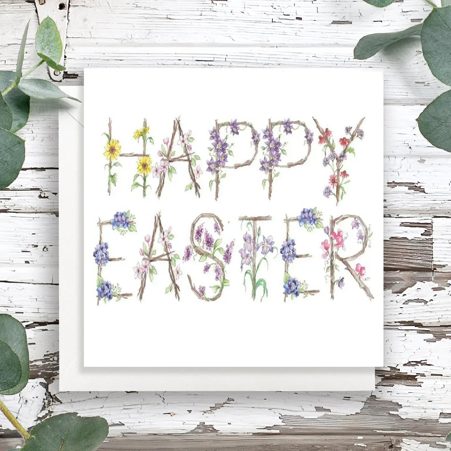 Handcrafted Happy Easter card with floral lettering on rustic wood background
