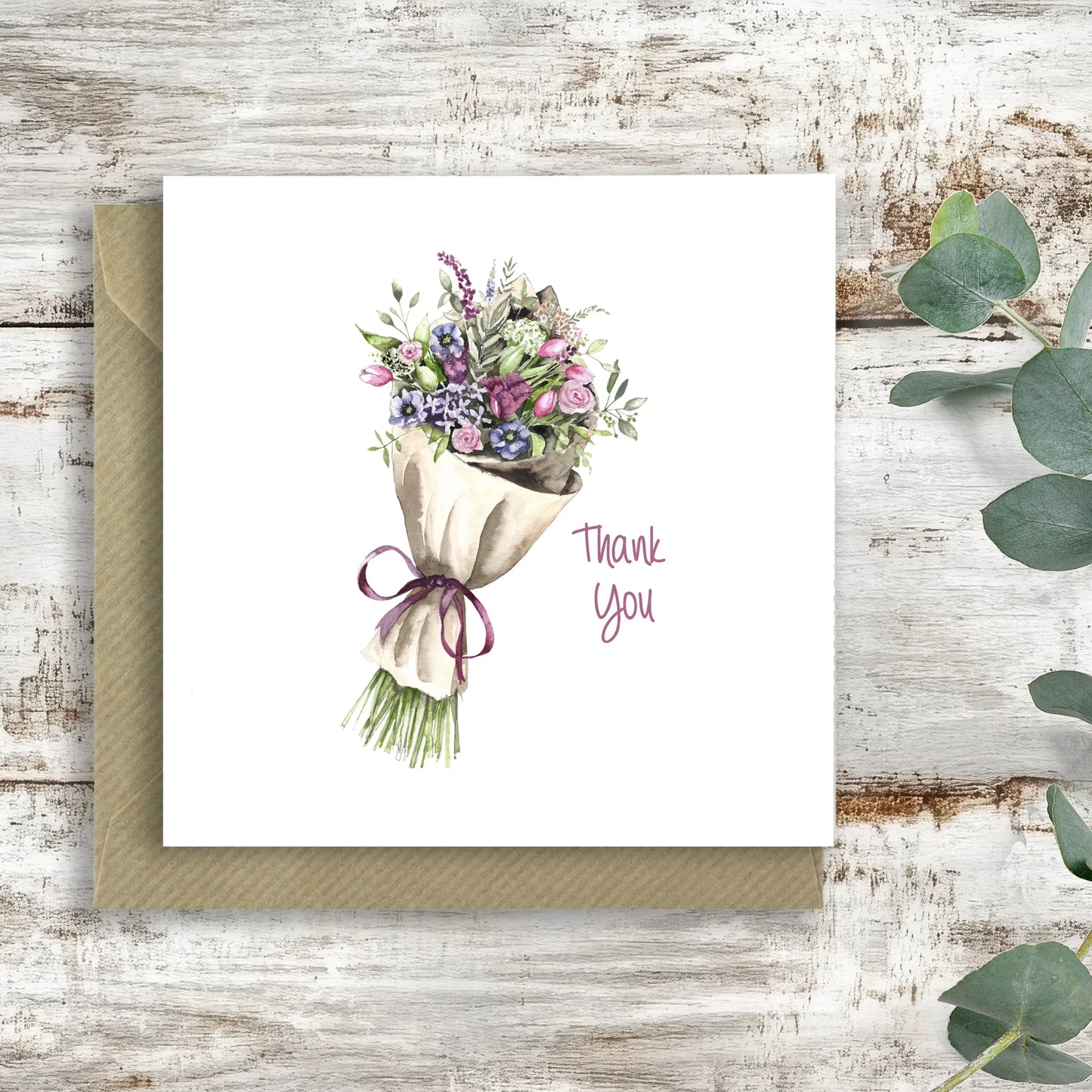 Handcrafted thank you card with illustrated bouquet of flowers on rustic wooden background