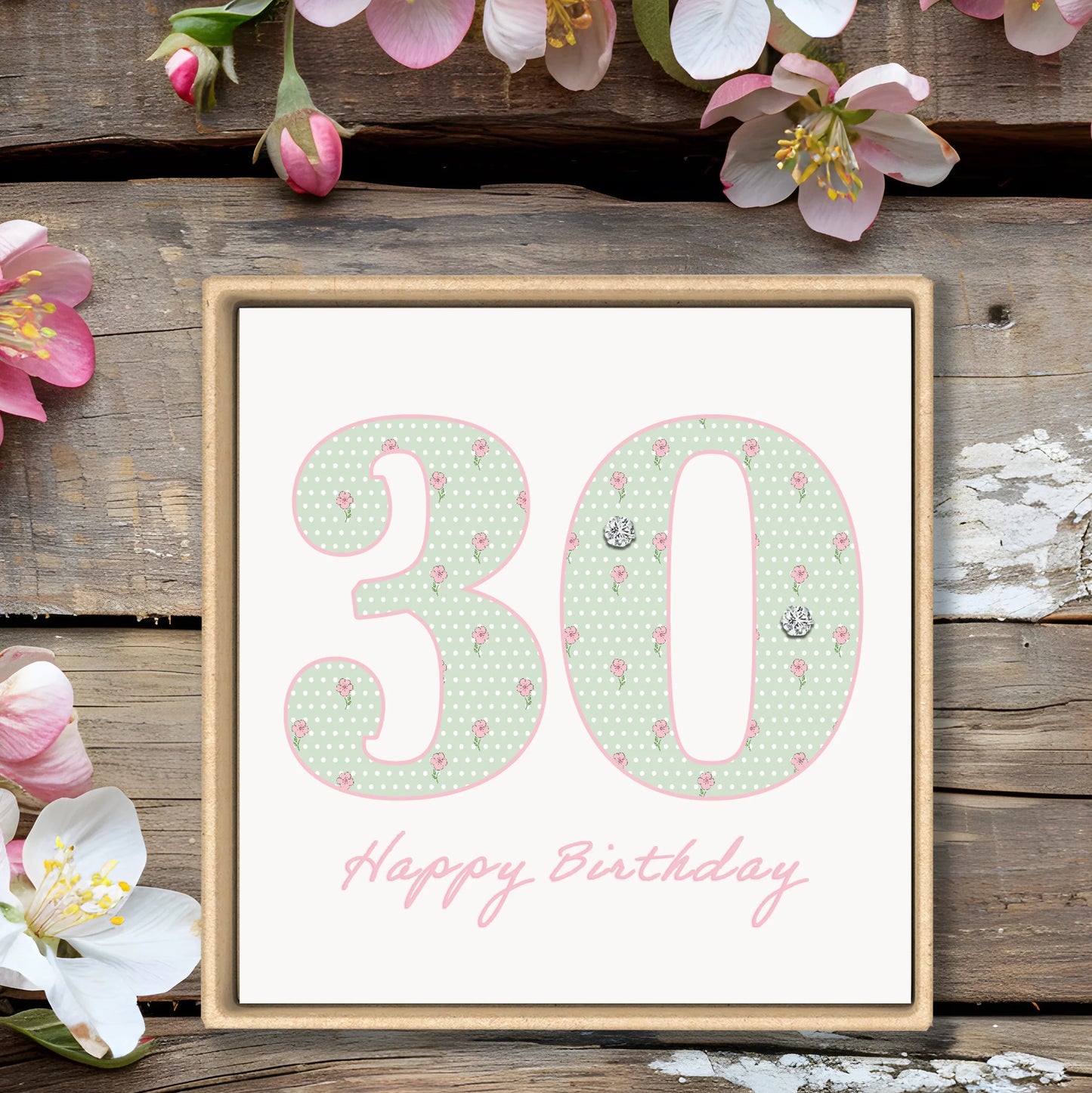 Floral 30th birthday card with pastel polka dots and pink flowers on rustic wood background