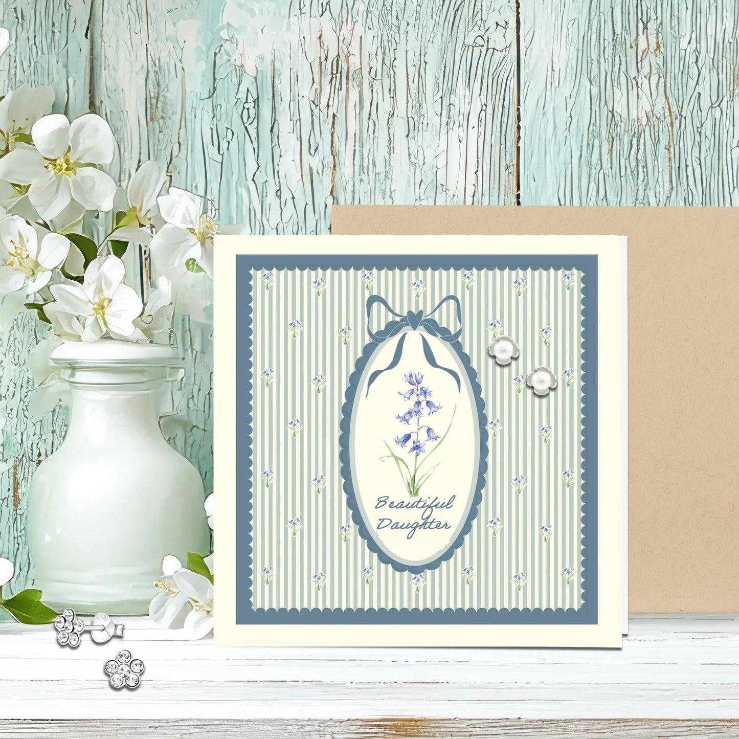 Floral jewellery gift card for daughter with pearl earrings, blue striped background, white blossoms