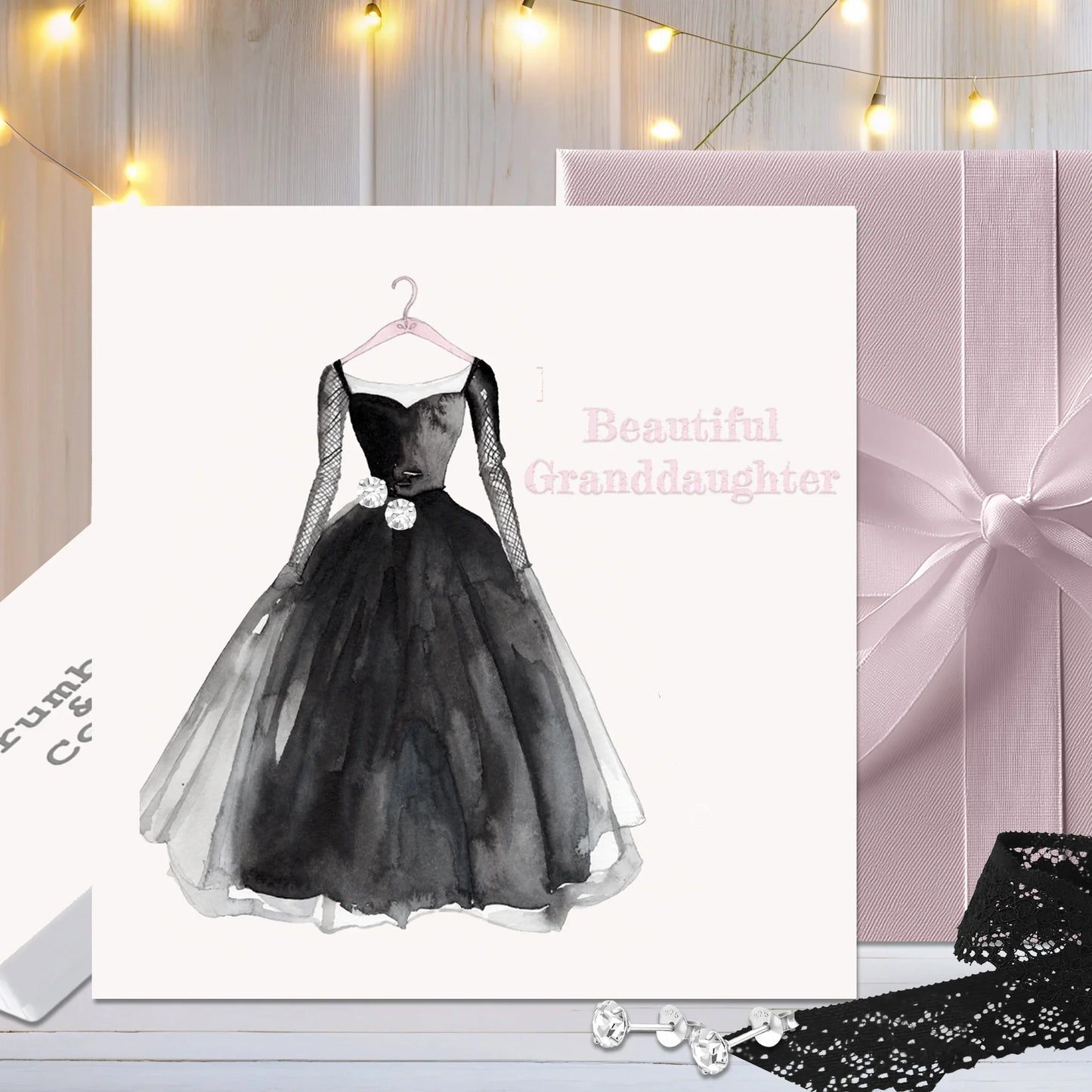 Greeting card with black dress illustration and 'Beautiful Granddaughter' text, gifts in background