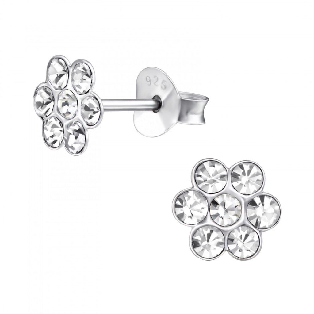Silver flower-shaped earrings with clear gemstones on a white background