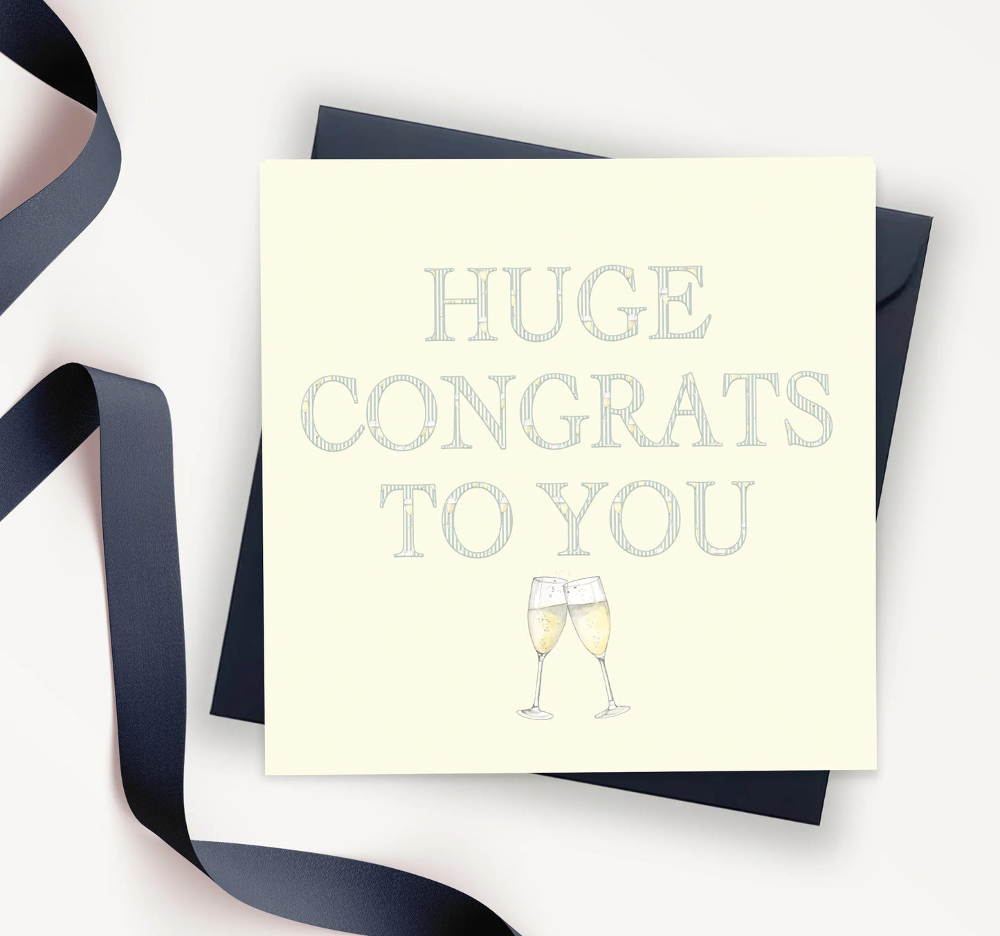 Congratulations greeting card with champagne glasses and navy envelope