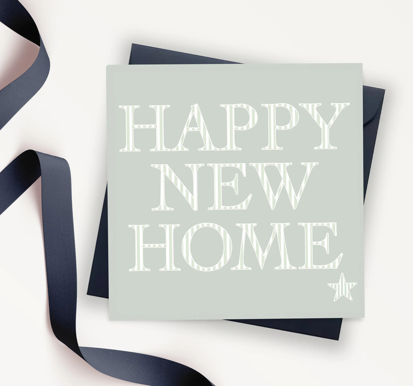Happy New Home card with bold white lettering and navy envelope, ideal for housewarming gift.