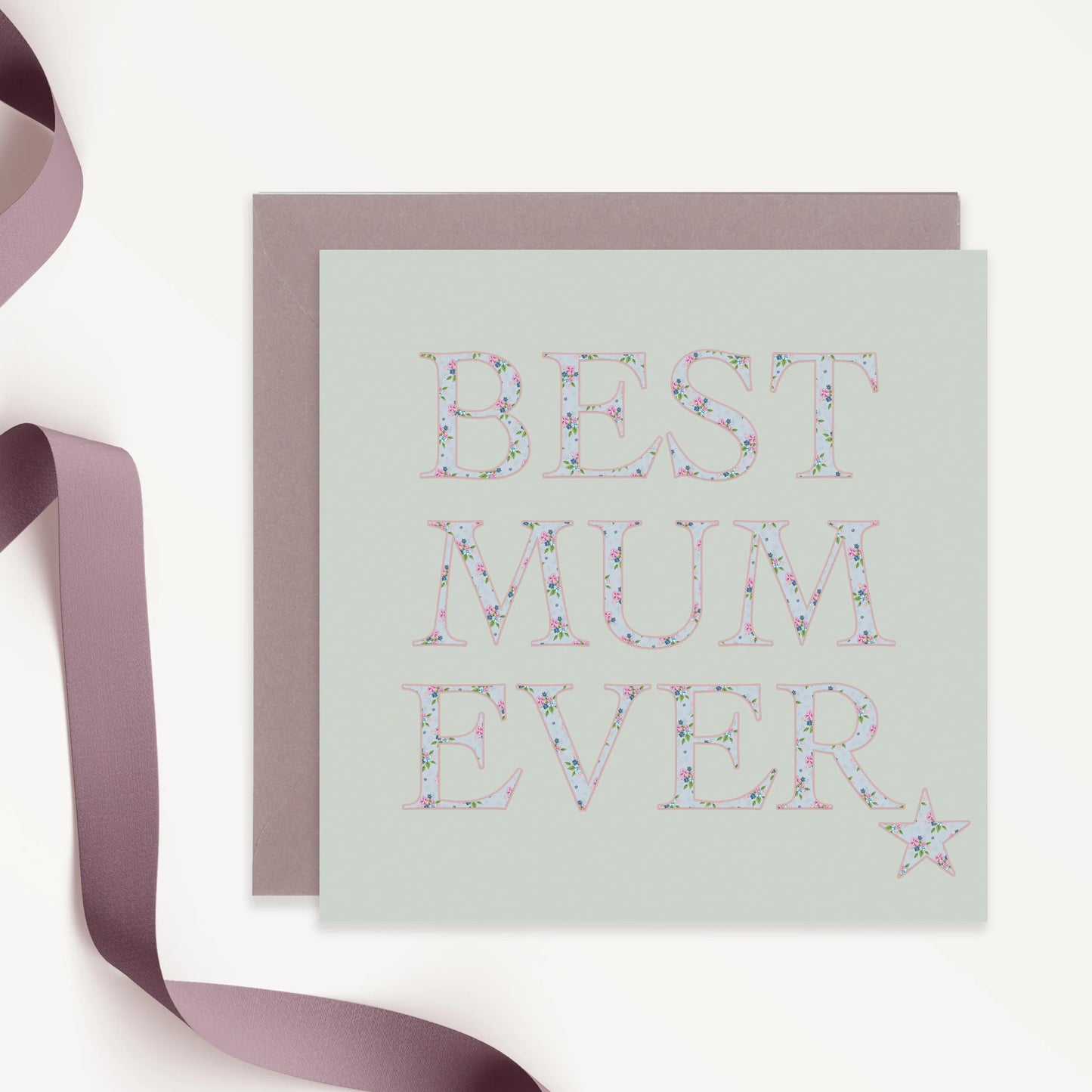 Square greeting card with floral 'Best Mum Ever' text, mauve envelope, and ribbon