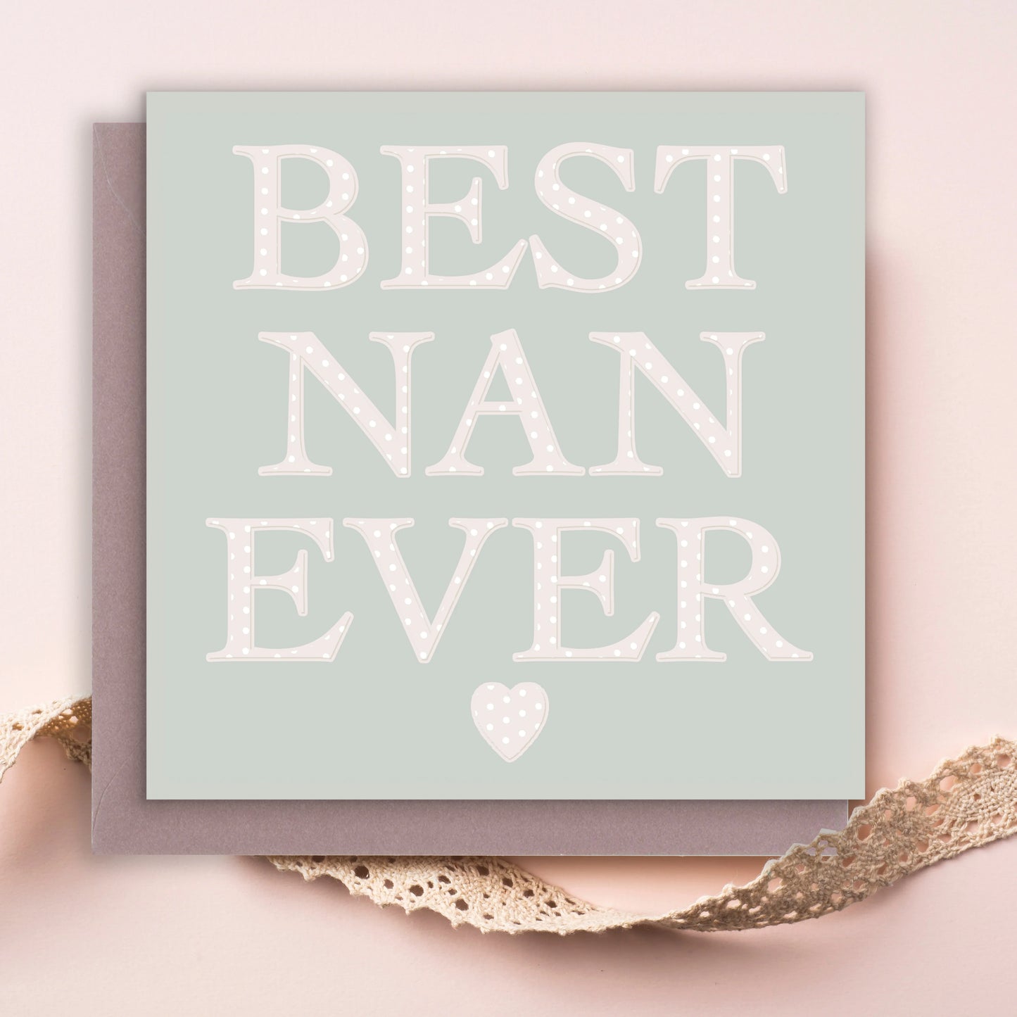Best Nan Ever greeting card with polka dot text and heart on pale background, lace accent