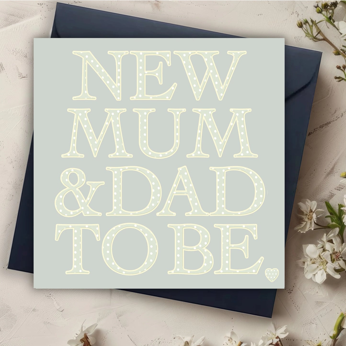 New mum and dad to be card with polka dot letters, navy envelope, floral accents