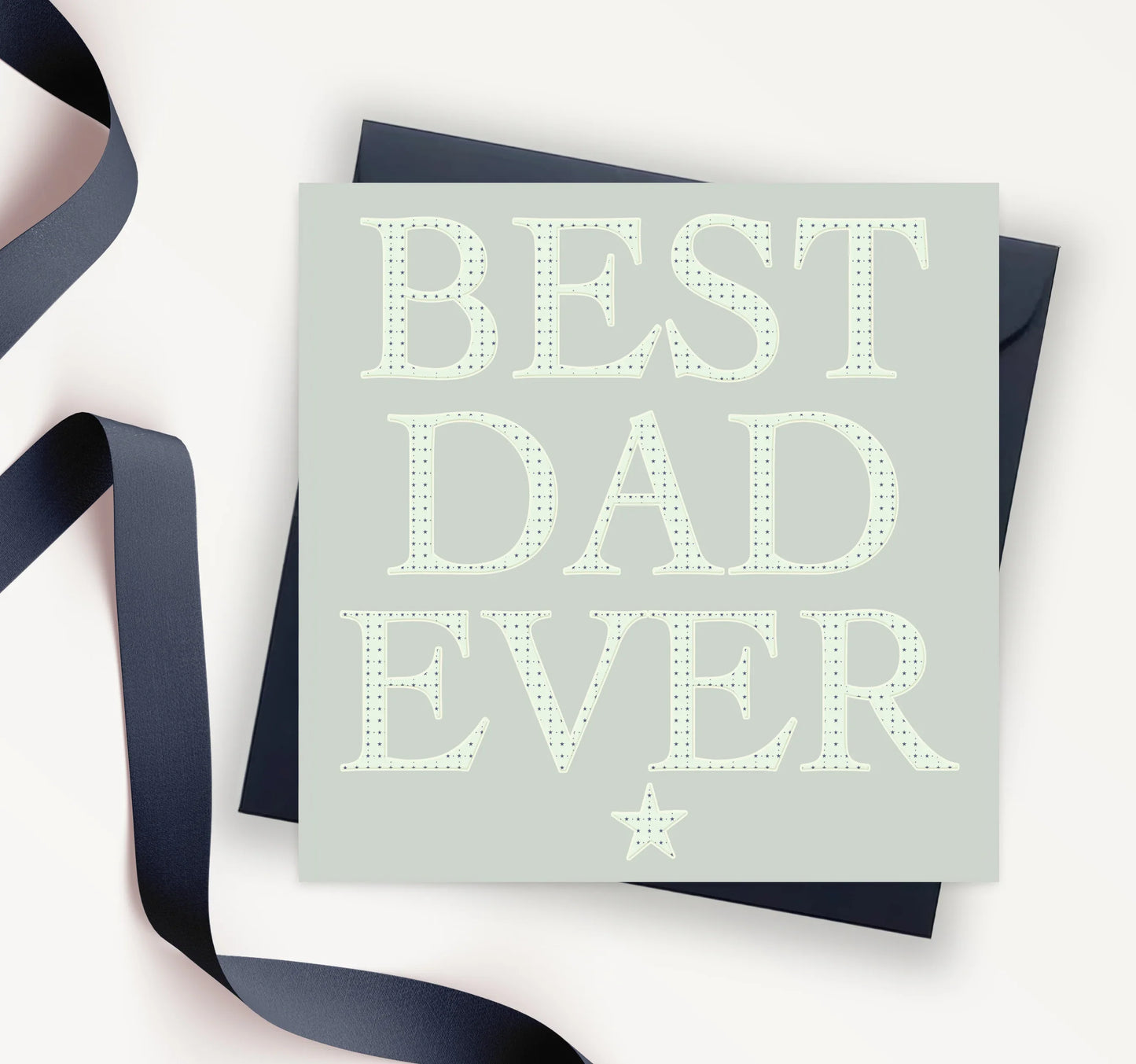 Square Father's Day card with 'BEST DAD EVER' text and star, navy envelope and ribbon