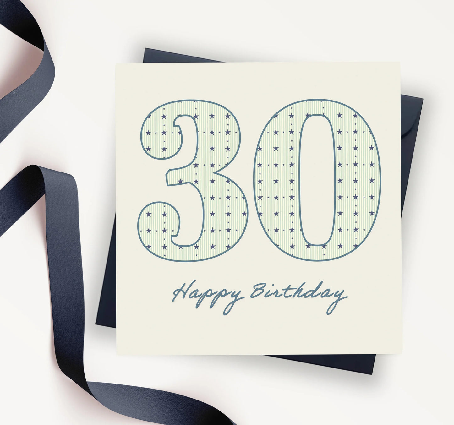 30th birthday card with star pattern, navy envelope, and ribbon on a white background