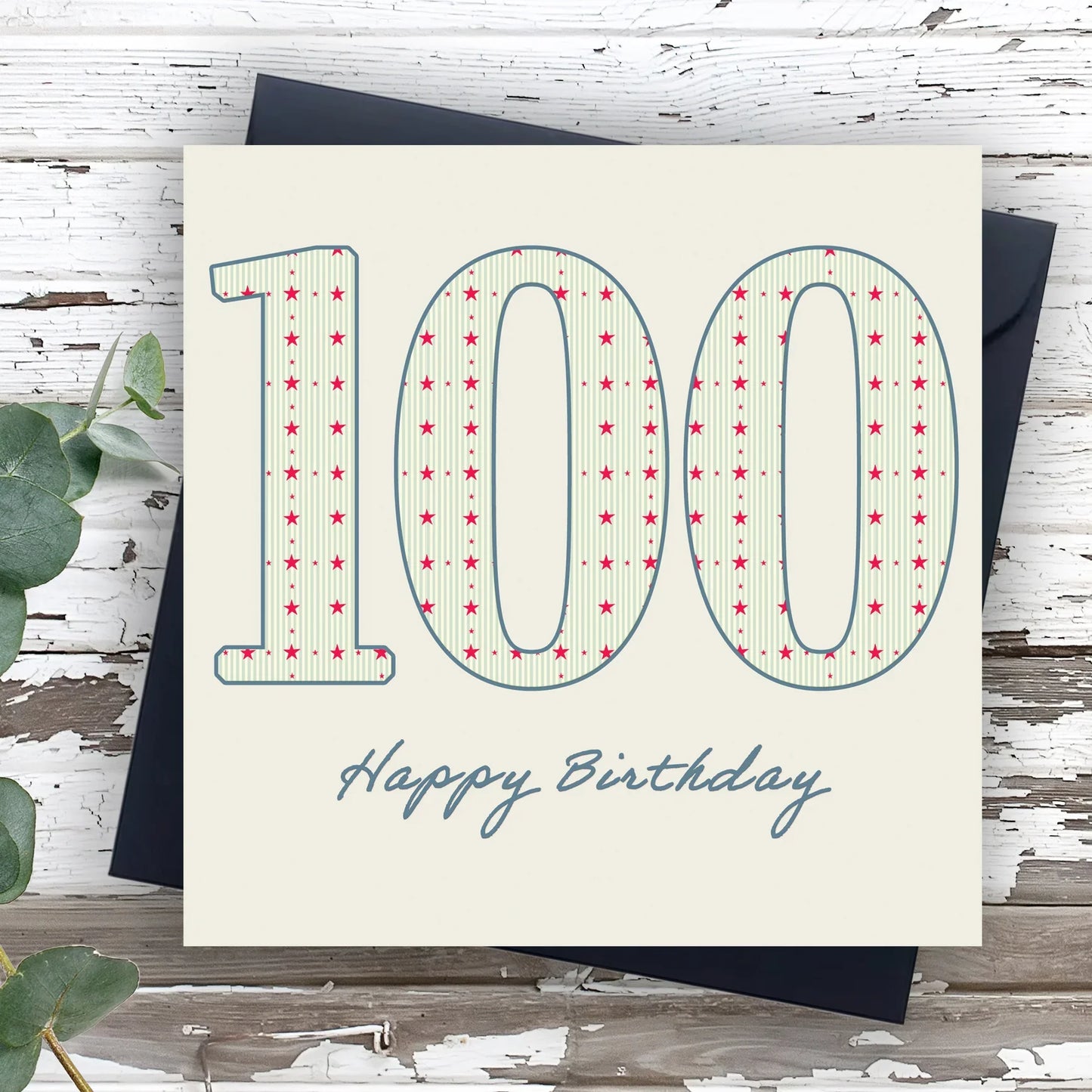 100th birthday card with large patterned numbers and 'Happy Birthday' text on rustic wood