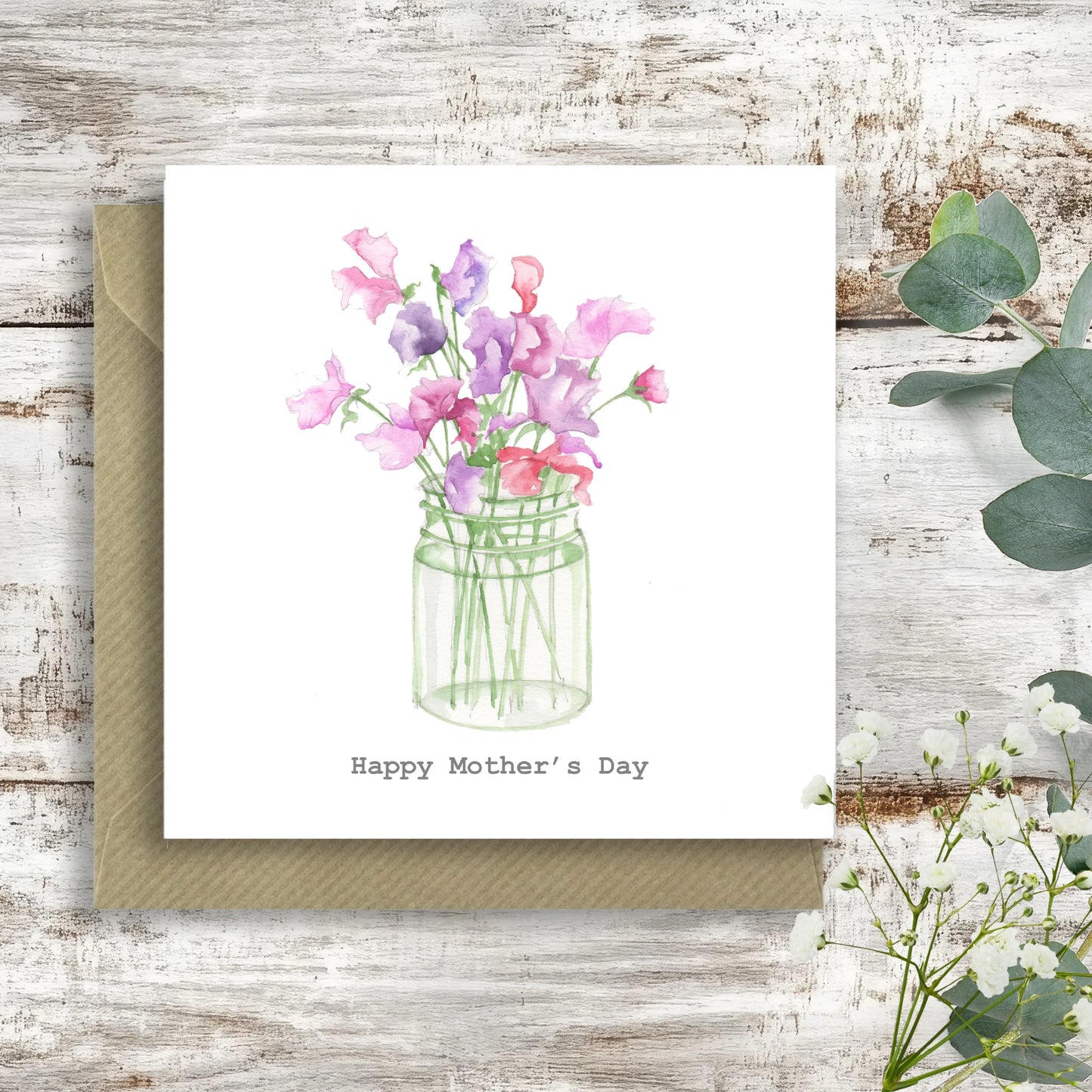 Mother's Day card with watercolor pink and purple flowers in a glass jar on rustic wood table
